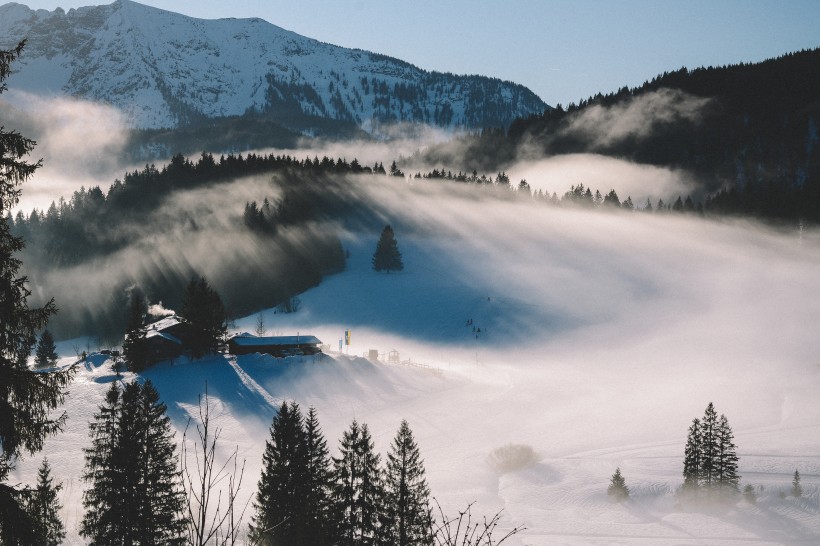 风中扬起白雾的冬日雪山风景图片第1张